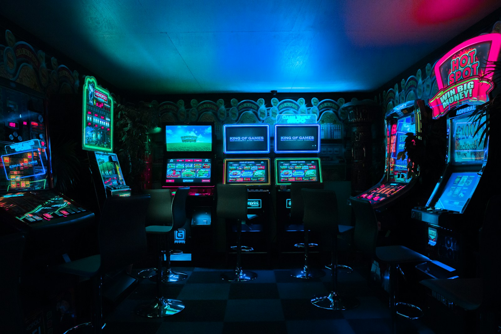 Neon-lit arcade corridor with classic cabinets