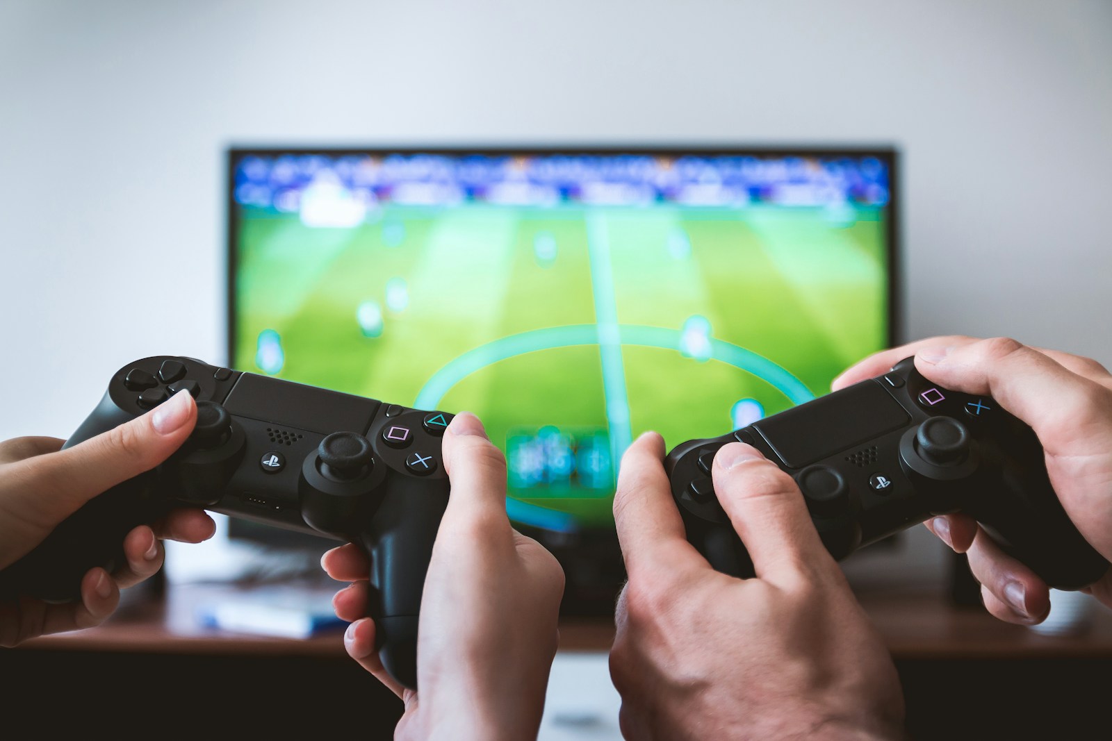 Friends playing video games together on a sofa